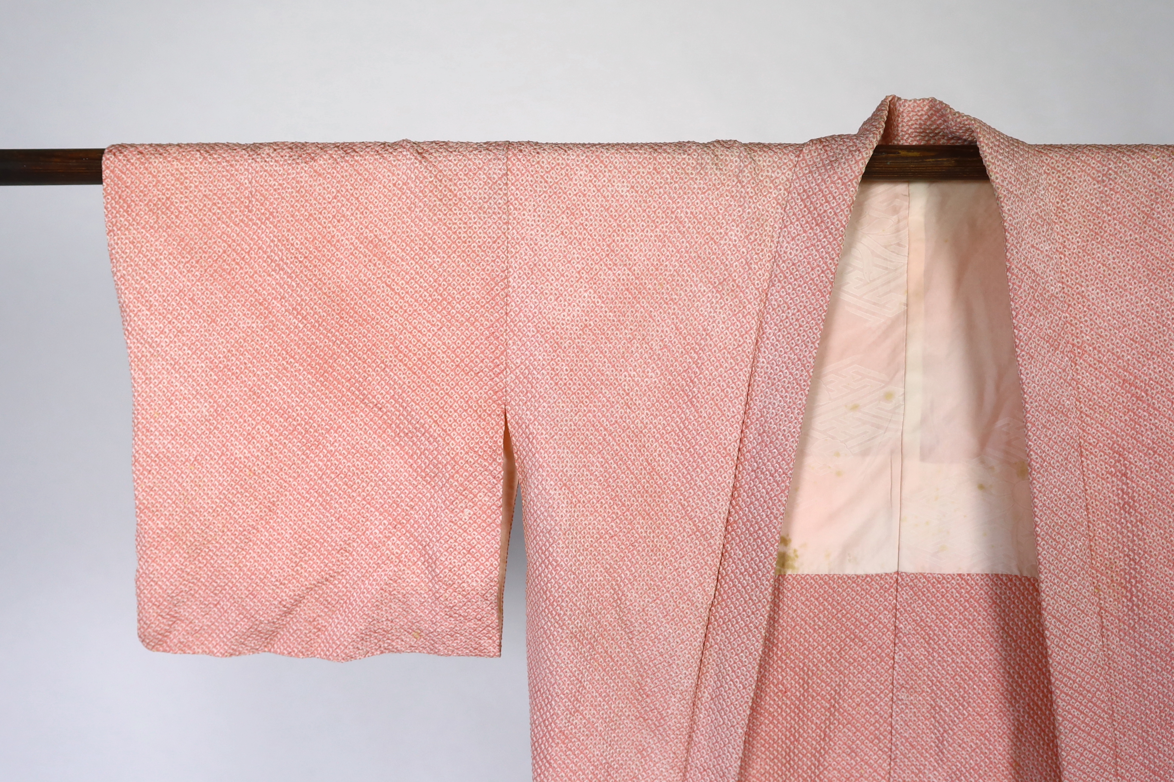 A Japanese Shibori kimono, the silk minutely tie-dyed into a raised spot like design by hand, circa 1920's. This design 'haori himo', lined with a silk damask, 69cm long